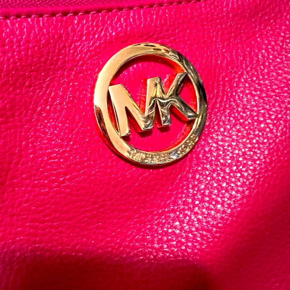 Michael Kors wristlet in pink.